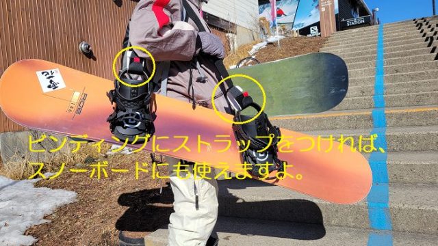 ショルダーキャリアストラップをスノーボードにつけて運んでいる写真。